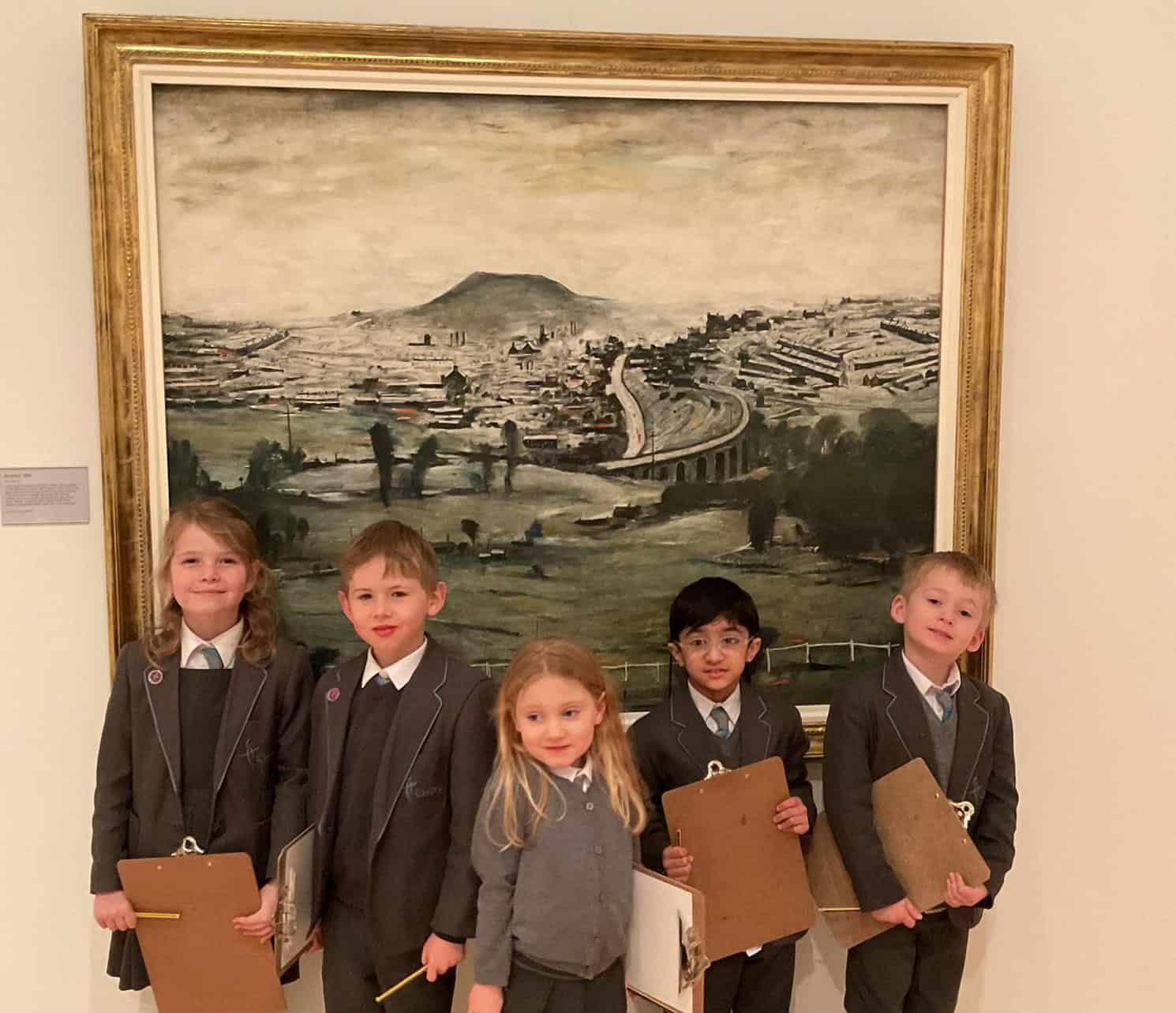 Pupils stood infront of painting at the Lowry.