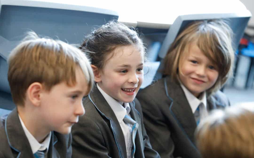 Two Pupils smiling at eachother